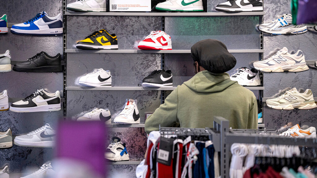 A customer looks at shoes for sale at a Hibbett Sports location in Richmond, California, US, on Tuesday, April 23, 2024. British sportswear and sneaker