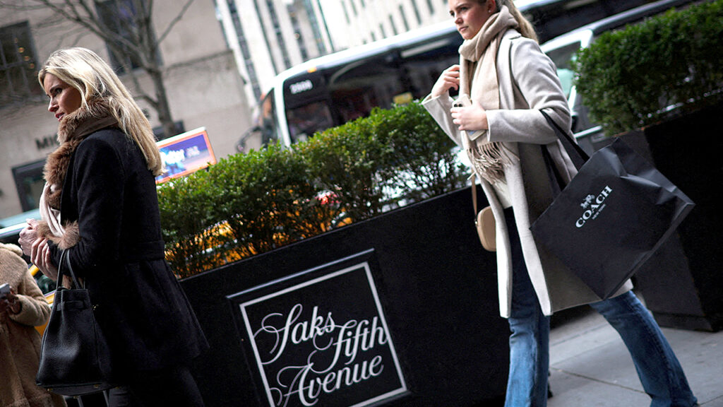 FILE PHOTO: Holiday shoppers walk outside the Saks Fifth Avenue flagship store in Manhattan in New York City, U.S., December 5, 2023. REUTERS/Mike